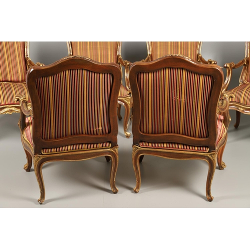 1212 - A SET OF SIX ITALIAN WALNUT AND PARCEL GILT OPEN ARMCHAIRS. by the contemporary designer and craftsm... 