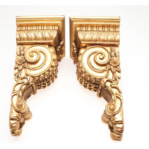 1213 - A PAIR OF 20TH CENTURY CARVED GILTWOOD WALL BRACKETS. each with stepped square shelves above heavily... 