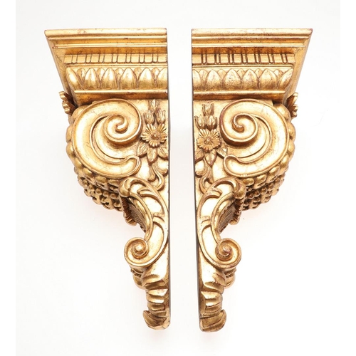 1213 - A PAIR OF 20TH CENTURY CARVED GILTWOOD WALL BRACKETS. each with stepped square shelves above heavily... 