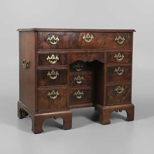 1216 - A GEORGE III MAHOGANY SECRETAIRE KNEEHOLE DESK. the moulded top above a secretaire section fitted wi... 