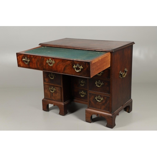 1216 - A GEORGE III MAHOGANY SECRETAIRE KNEEHOLE DESK. the moulded top above a secretaire section fitted wi... 