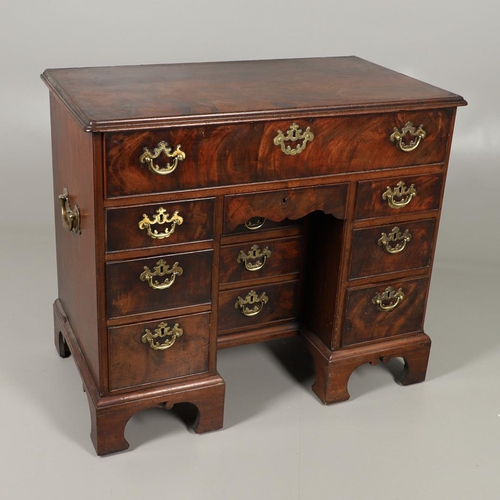 1216 - A GEORGE III MAHOGANY SECRETAIRE KNEEHOLE DESK. the moulded top above a secretaire section fitted wi... 