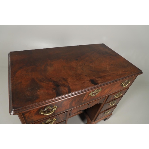 1216 - A GEORGE III MAHOGANY SECRETAIRE KNEEHOLE DESK. the moulded top above a secretaire section fitted wi... 