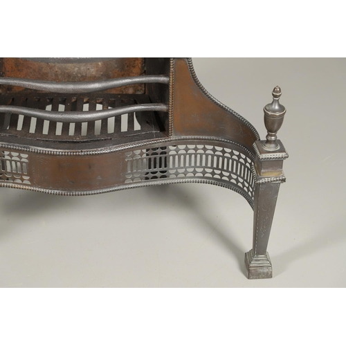 1217 - AN ADAMS STYLE CAST IRON FIRE BASKET. of serpentine form with pierced copper front, tapering square ... 