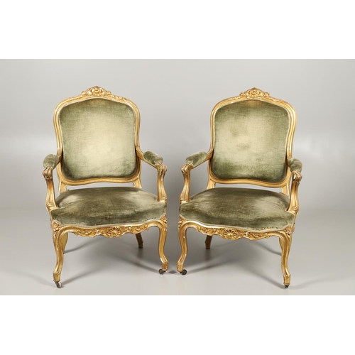 1219 - A PAIR OF 19TH CENTURY LOUIS XV STYLE GILTWOOD FAUTEUILS A LA REINES. each with a carved show frame ... 