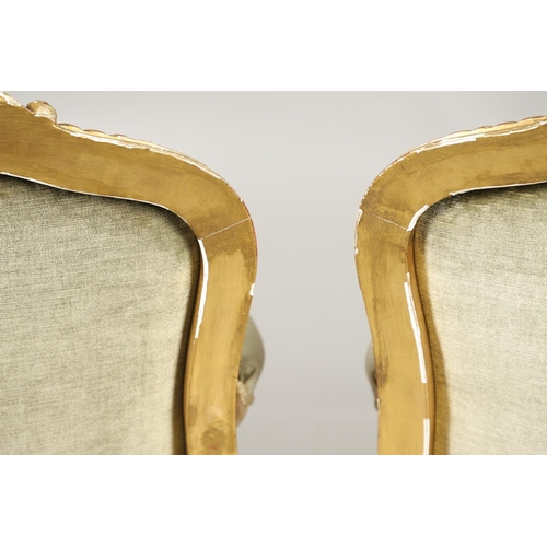 1219 - A PAIR OF 19TH CENTURY LOUIS XV STYLE GILTWOOD FAUTEUILS A LA REINES. each with a carved show frame ... 