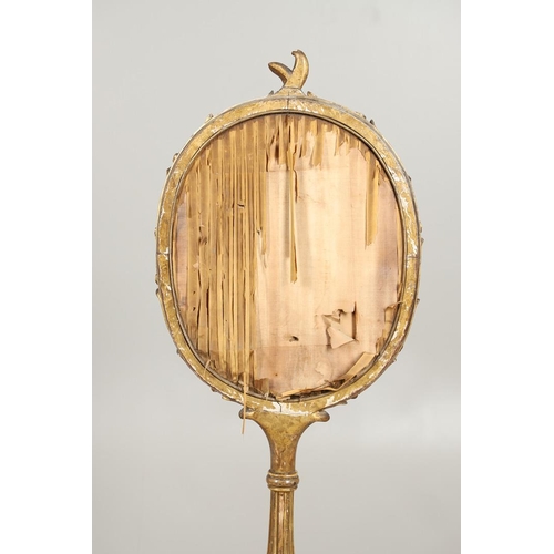 1220 - A 19TH CENTURY GILTWOOD POLE SCREEN. the oval floral silkwork panel within a carved naturalistic fra... 