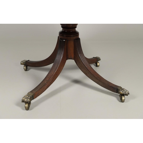 1221 - A REGENCY MAHOGANY CIRCULAR LIBRARY TABLE. the top with tooled leather insert, on a turned column an... 