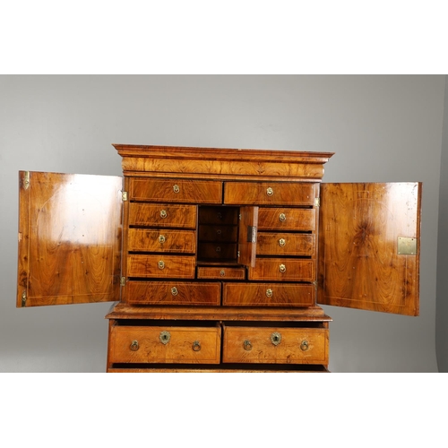 1222 - A GEORGE II WALNUT CABINET ON CHEST. the cabinet with moulded cornice above eleven fitted drawers to... 