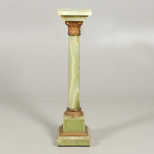 1225 - A GILT METAL MOUNTED ONYX COLUMN. with gold painted Corinthian Capital column to a square stepped ba... 