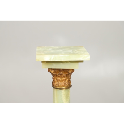 1225 - A GILT METAL MOUNTED ONYX COLUMN. with gold painted Corinthian Capital column to a square stepped ba... 