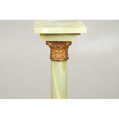 1225 - A GILT METAL MOUNTED ONYX COLUMN. with gold painted Corinthian Capital column to a square stepped ba... 