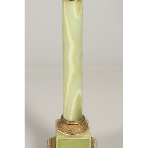 1225 - A GILT METAL MOUNTED ONYX COLUMN. with gold painted Corinthian Capital column to a square stepped ba... 