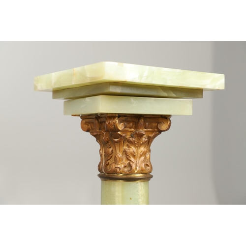 1225 - A GILT METAL MOUNTED ONYX COLUMN. with gold painted Corinthian Capital column to a square stepped ba... 