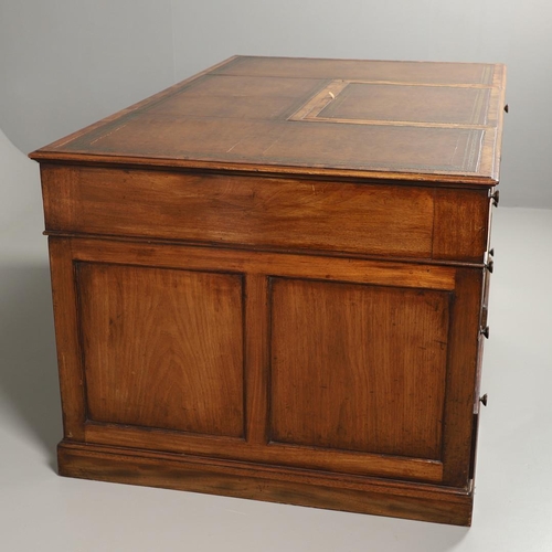 1227 - A 19TH CENTURY MAHOGANY PARTNERS DESK. the tooled and segmented leather top with central writing slo... 