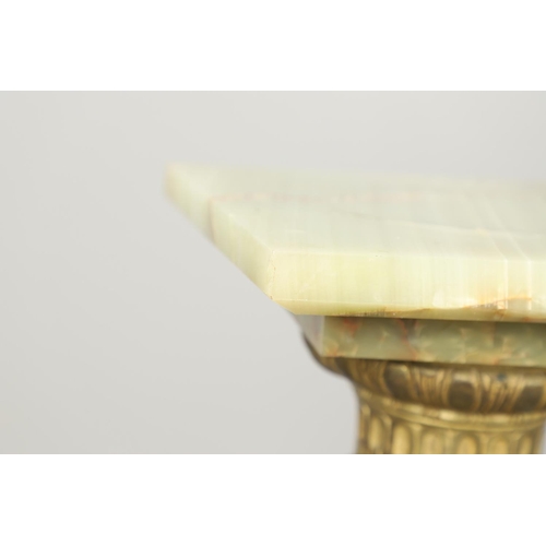 1228 - AN ONYX AND GILT METAL COLUMN JARDINIERE STAND. the cylindrical column with gilt metal mounts, cast ... 