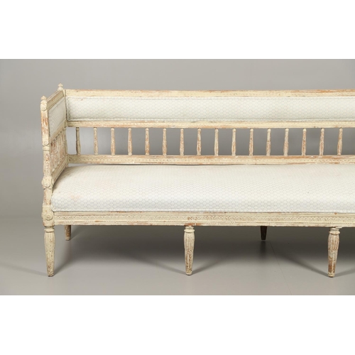 1230 - A SWEDISH LOUIS XVI STYLE PAINTED PINE SALON SOFA.with padded and leaf carved spindle back, flower r... 