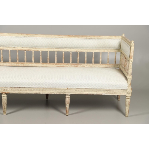 1230 - A SWEDISH LOUIS XVI STYLE PAINTED PINE SALON SOFA.with padded and leaf carved spindle back, flower r... 