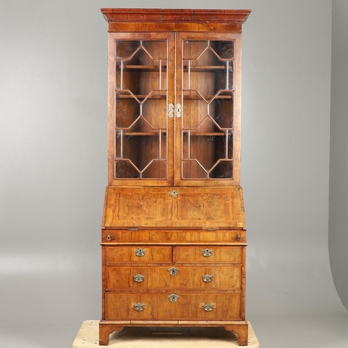 1232 - AN 18TH CENTURY WALNUT BUREAU BOOKCASE. the astrigal glazed top section enclosing three shelves, the... 