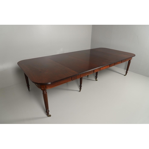 1238 - A REGENCY MAHOGANY EXTENDING DINING TABLE. the rectangular top with a reeded edge and concertina act... 