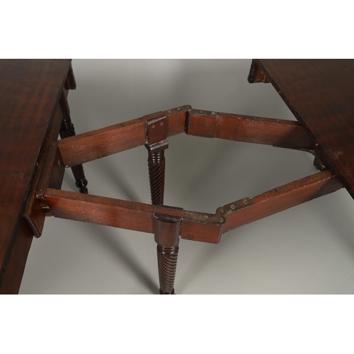 1238 - A REGENCY MAHOGANY EXTENDING DINING TABLE. the rectangular top with a reeded edge and concertina act... 