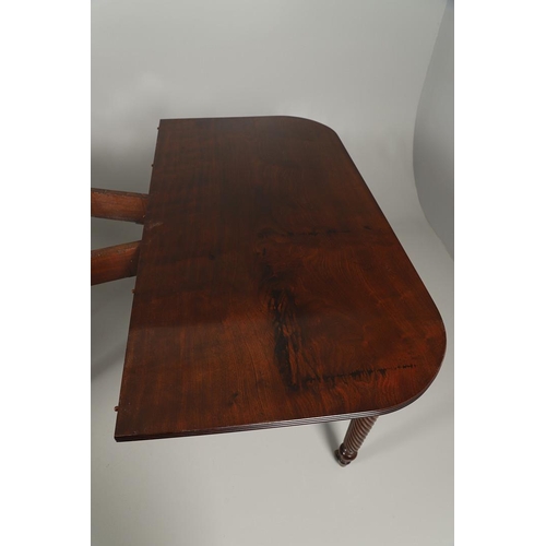 1238 - A REGENCY MAHOGANY EXTENDING DINING TABLE. the rectangular top with a reeded edge and concertina act... 