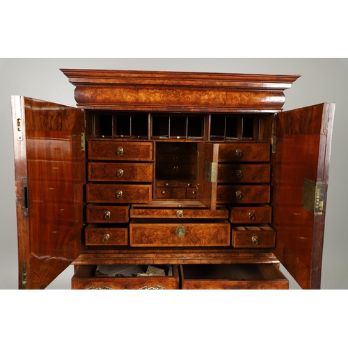 1251 - AN EARLY 18TH CENTURY WALNUT ESTATE CUPBOARD. the cushion cornice with unusual hinged lockable front... 