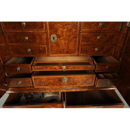 1251 - AN EARLY 18TH CENTURY WALNUT ESTATE CUPBOARD. the cushion cornice with unusual hinged lockable front... 