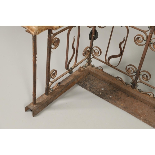 1252 - A 19TH CENTURY LEATHER AND WROUGHT IRON CLUB FENDER. the pale green leather seat over an ornate wrou... 