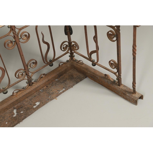 1252 - A 19TH CENTURY LEATHER AND WROUGHT IRON CLUB FENDER. the pale green leather seat over an ornate wrou... 