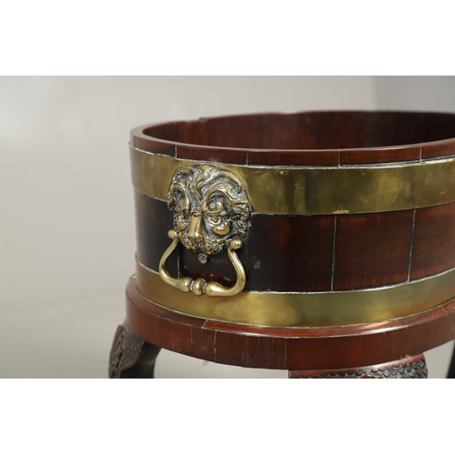 1253 - A GEORGE III BRASS BOUND MAHOGANY WINE COOLER. possibly Irish, of oval shape with finely cast lion m... 