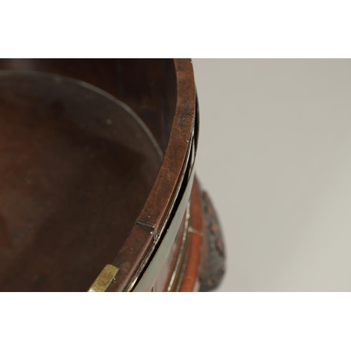 1253 - A GEORGE III BRASS BOUND MAHOGANY WINE COOLER. possibly Irish, of oval shape with finely cast lion m... 