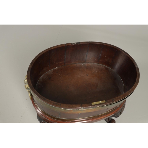 1253 - A GEORGE III BRASS BOUND MAHOGANY WINE COOLER. possibly Irish, of oval shape with finely cast lion m... 