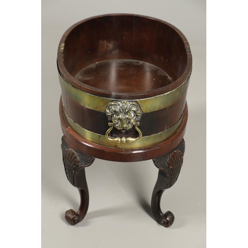 1253 - A GEORGE III BRASS BOUND MAHOGANY WINE COOLER. possibly Irish, of oval shape with finely cast lion m... 