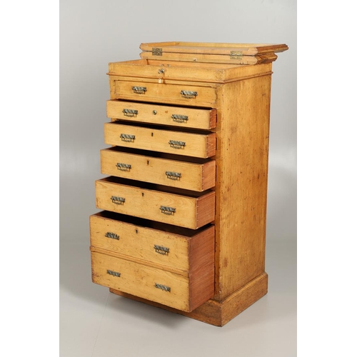 1255 - A LATE VICTORIAN OAK WELLINGTON STYLE CHEST OF DRAWERS. the hinged top opening to reveal sectional s... 