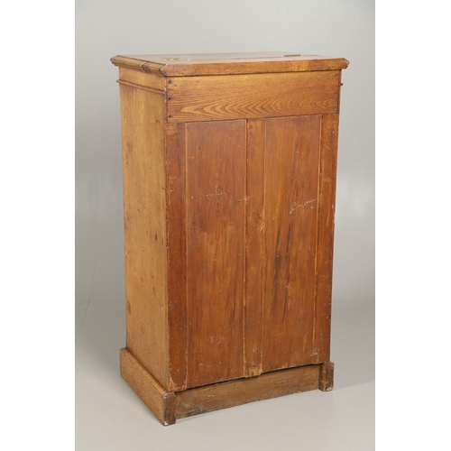 1255 - A LATE VICTORIAN OAK WELLINGTON STYLE CHEST OF DRAWERS. the hinged top opening to reveal sectional s... 