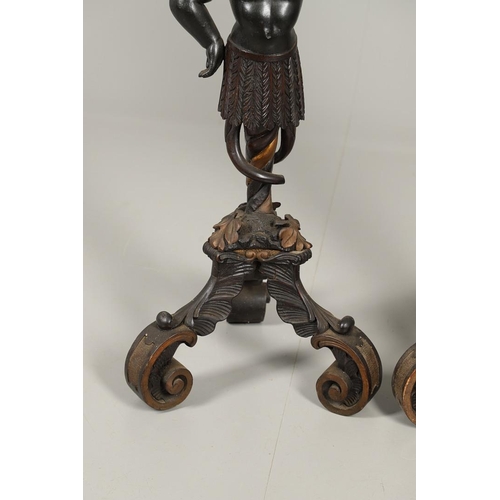 1256 - A PAIR OF PAINTED BLACKAMOOR TORCHERE STANDS. each carved figure holding aloft a shaped stand upon s... 