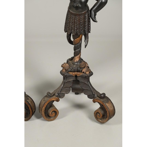 1256 - A PAIR OF PAINTED BLACKAMOOR TORCHERE STANDS. each carved figure holding aloft a shaped stand upon s... 