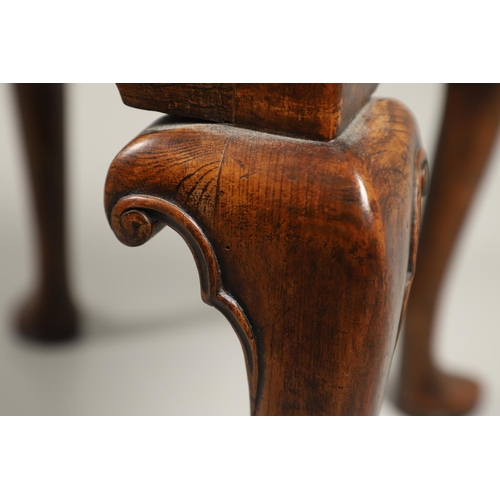 1260 - A GEORGE II WALNUT FOOTSTOOL. the rectangular frame upon scroll carved cabriole legs and spade feet,... 