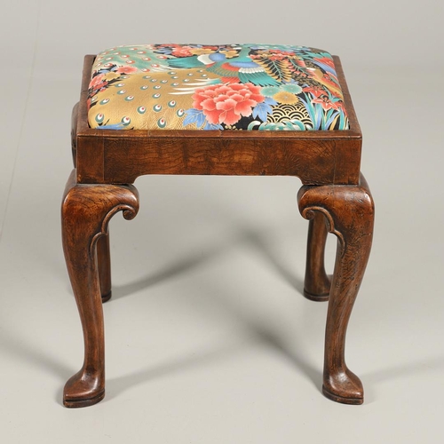 1260 - A GEORGE II WALNUT FOOTSTOOL. the rectangular frame upon scroll carved cabriole legs and spade feet,... 