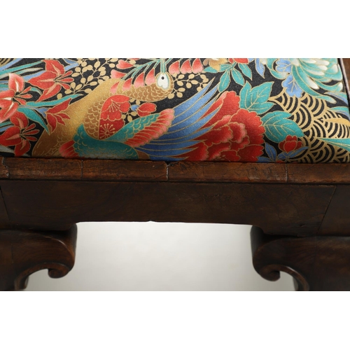 1260 - A GEORGE II WALNUT FOOTSTOOL. the rectangular frame upon scroll carved cabriole legs and spade feet,... 