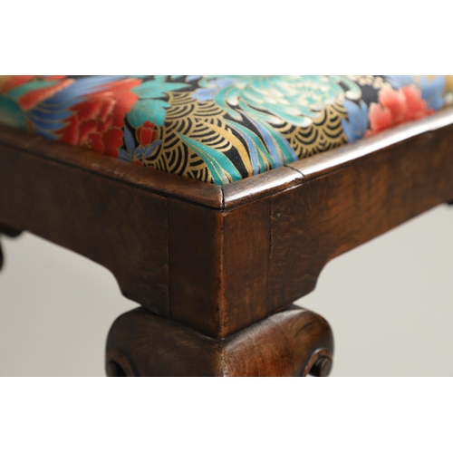 1260 - A GEORGE II WALNUT FOOTSTOOL. the rectangular frame upon scroll carved cabriole legs and spade feet,... 