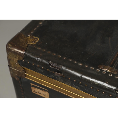 1263 - AN EARLY 20TH CENTURY BRASS BOUND LEATHER STEAMER TRUNK. with retailer's label for Trunk & Bag Co Lo... 