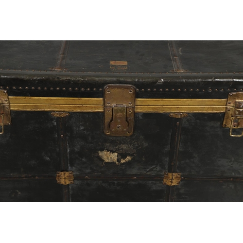 1263 - AN EARLY 20TH CENTURY BRASS BOUND LEATHER STEAMER TRUNK. with retailer's label for Trunk & Bag Co Lo... 