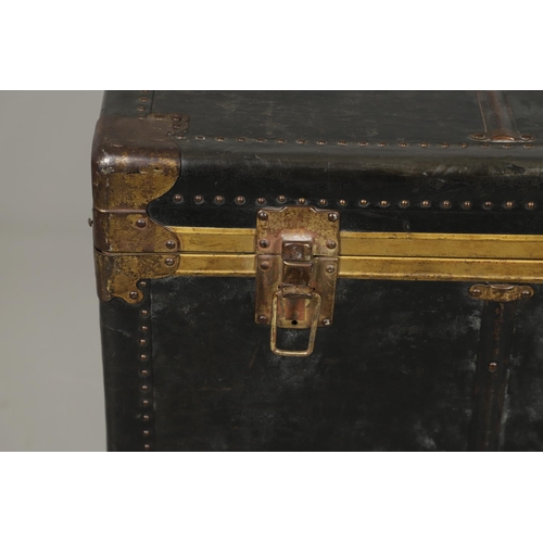 1263 - AN EARLY 20TH CENTURY BRASS BOUND LEATHER STEAMER TRUNK. with retailer's label for Trunk & Bag Co Lo... 