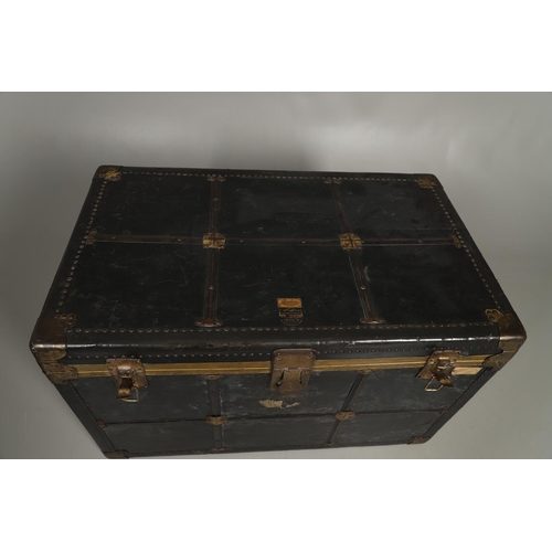 1263 - AN EARLY 20TH CENTURY BRASS BOUND LEATHER STEAMER TRUNK. with retailer's label for Trunk & Bag Co Lo... 