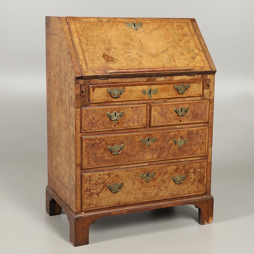 1264 - AN 18TH CENTURY WALNUT BUREAU. of small proportions with feathered crossbanding, the fall front encl... 