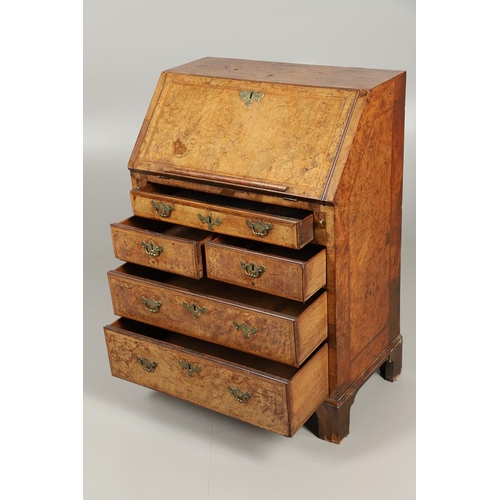 1264 - AN 18TH CENTURY WALNUT BUREAU. of small proportions with feathered crossbanding, the fall front encl... 