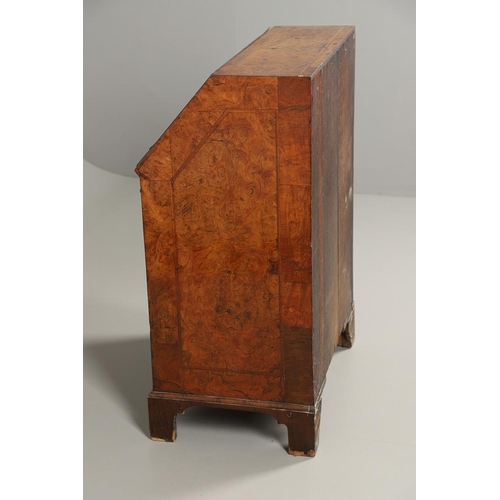 1264 - AN 18TH CENTURY WALNUT BUREAU. of small proportions with feathered crossbanding, the fall front encl... 