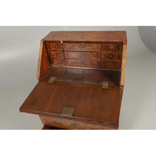 1264 - AN 18TH CENTURY WALNUT BUREAU. of small proportions with feathered crossbanding, the fall front encl... 